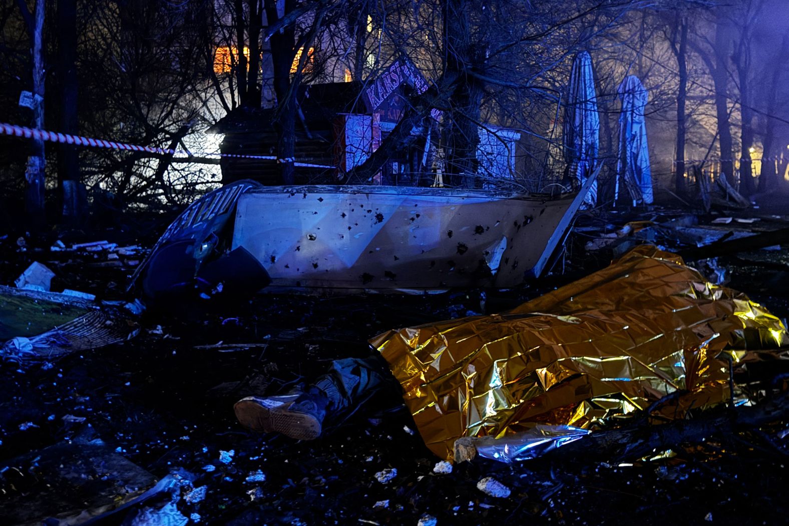 A body is covered at the site of an air attack in Zaporizhzhia, Ukraine, on Thursday, November 20.