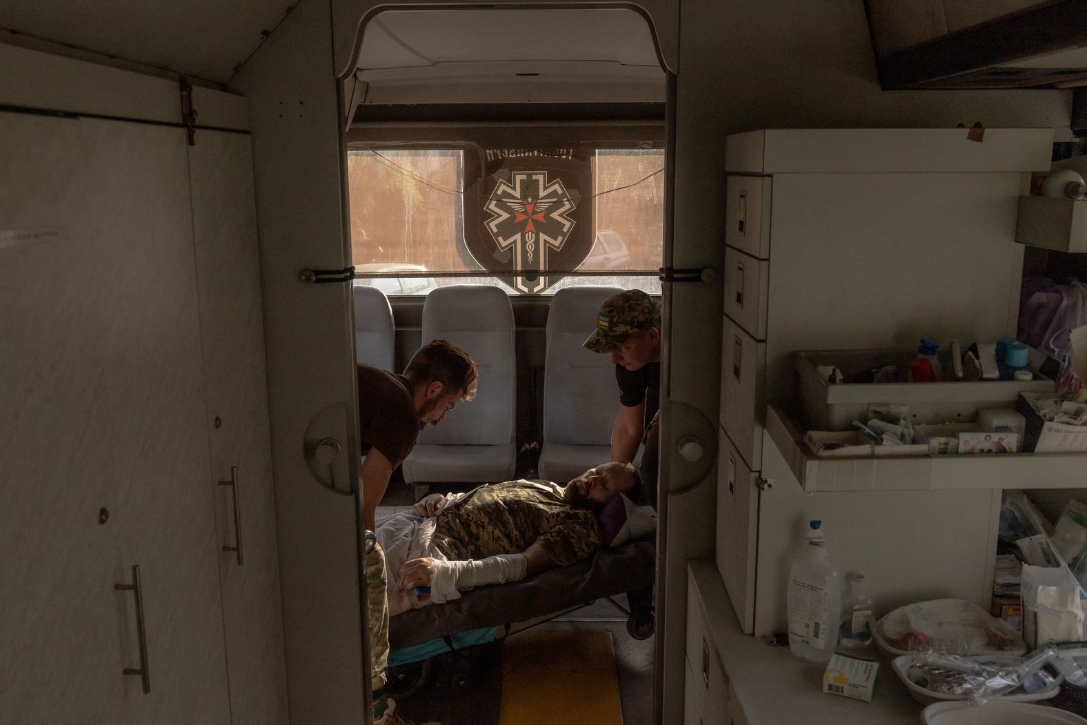 Paramedics with the Hospitallers, a volunteer medical battalion, load a wounded Ukrainian serviceman onto a medical evacuation bus in the country’s Donetsk region on Sunday, October 6.