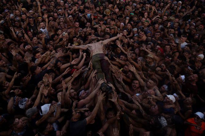 A man jumps in the crowd during the Cascamorras festival in Baza, Spain, on Friday, September 6.