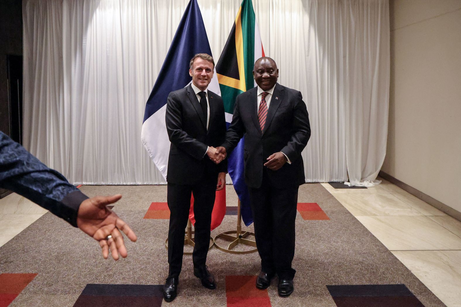 French President Emmanuel Macron, left, shakes hands with South African President Cyril Ramaphosa during a meeting ahead of the<a  href="/mt/?noimg=&dark=on&url=https%3a%2f%2fwww.cnn.com%2f2025%2f11%2f23%2fafrica%2fg20-south-africa-ends-trump-boycott-intl">G20 summit</a> in Sandton, South Africa, on Friday, November 21.