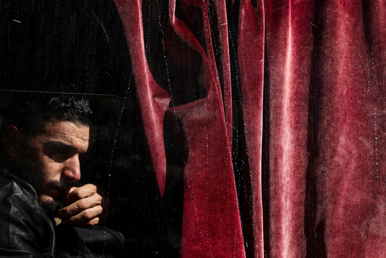 A man sits on a bus at the Masnaa border crossing after fleeing from Lebanon into Syria to escape the ongoing hostilities between Israel and Hezbollah on Sunday, October 27.