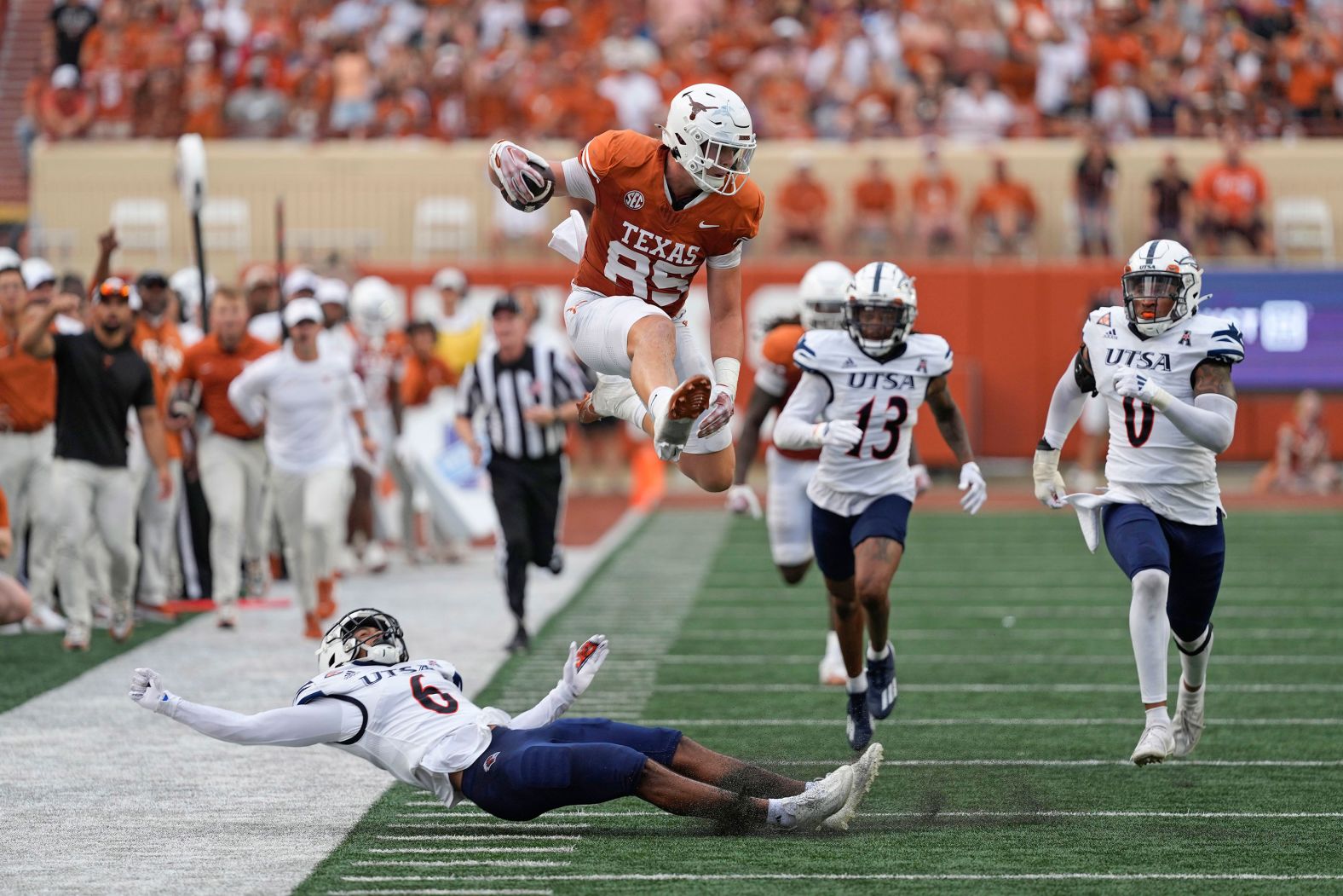 Texas Longhorns tight end Gunnar Helm leaps over UTSA defensive back Elliott Davison during a college football game in Austin, Texas, on Saturday, September 14.