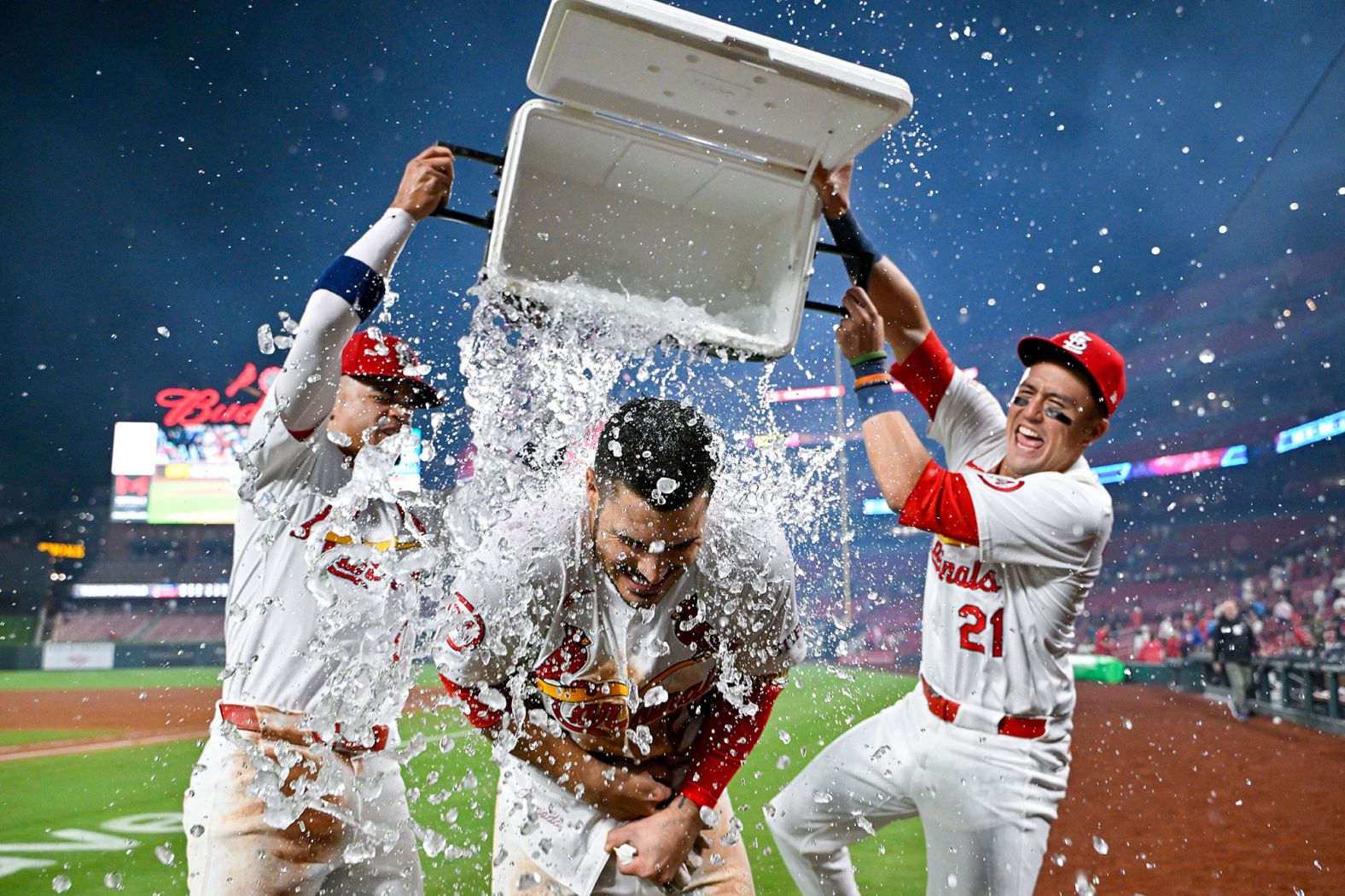 St. Louis Cardinals third baseman Nolan Arenado is doused by teammates Masyn Winn, left, and Lars Nootbaar after he hit a walk-off grand slam to defeat the Milwaukee Brewers on Wednesday, August 21.