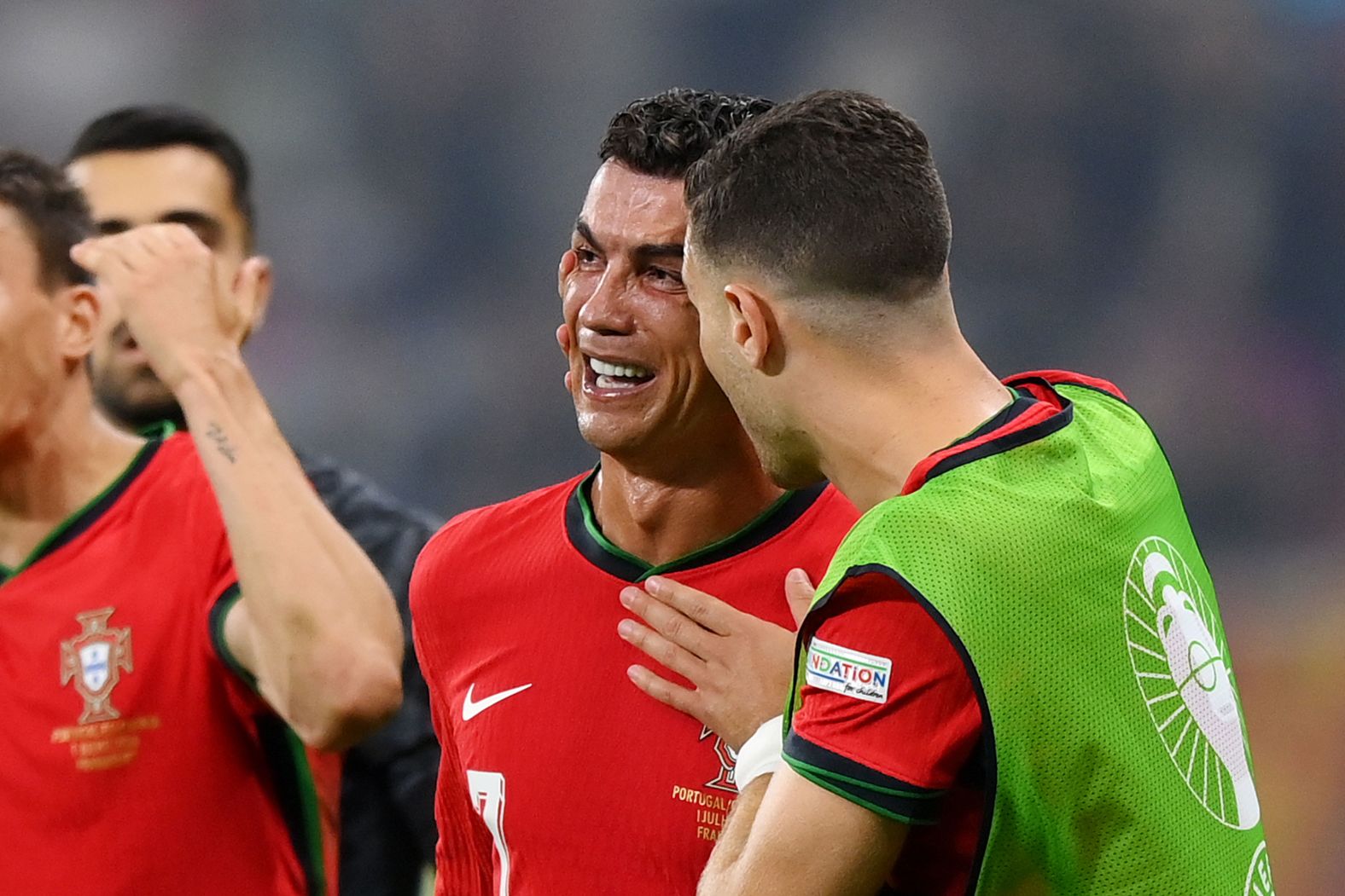 Portugal star Cristiano Ronaldo is consoled by a teammate during the Euro 2024 match against Slovenia on Monday, July 1. Ronaldo was upset that he had a penalty saved by Slovenian goalkeeper Jan Oblak in extra time, <a href="index.php?page=&url=https%3A%2F%2Fwww.cnn.com%2F2024%2F07%2F01%2Fsport%2Fportugal-slovenia-ronaldo-last-16-euro-2024-spt-intl%2Findex.html">but Portugal went on to win anyway in a penalty shootout</a> after the match ended scoreless. Ronaldo made amends by scoring one of the penalties in the shootout.