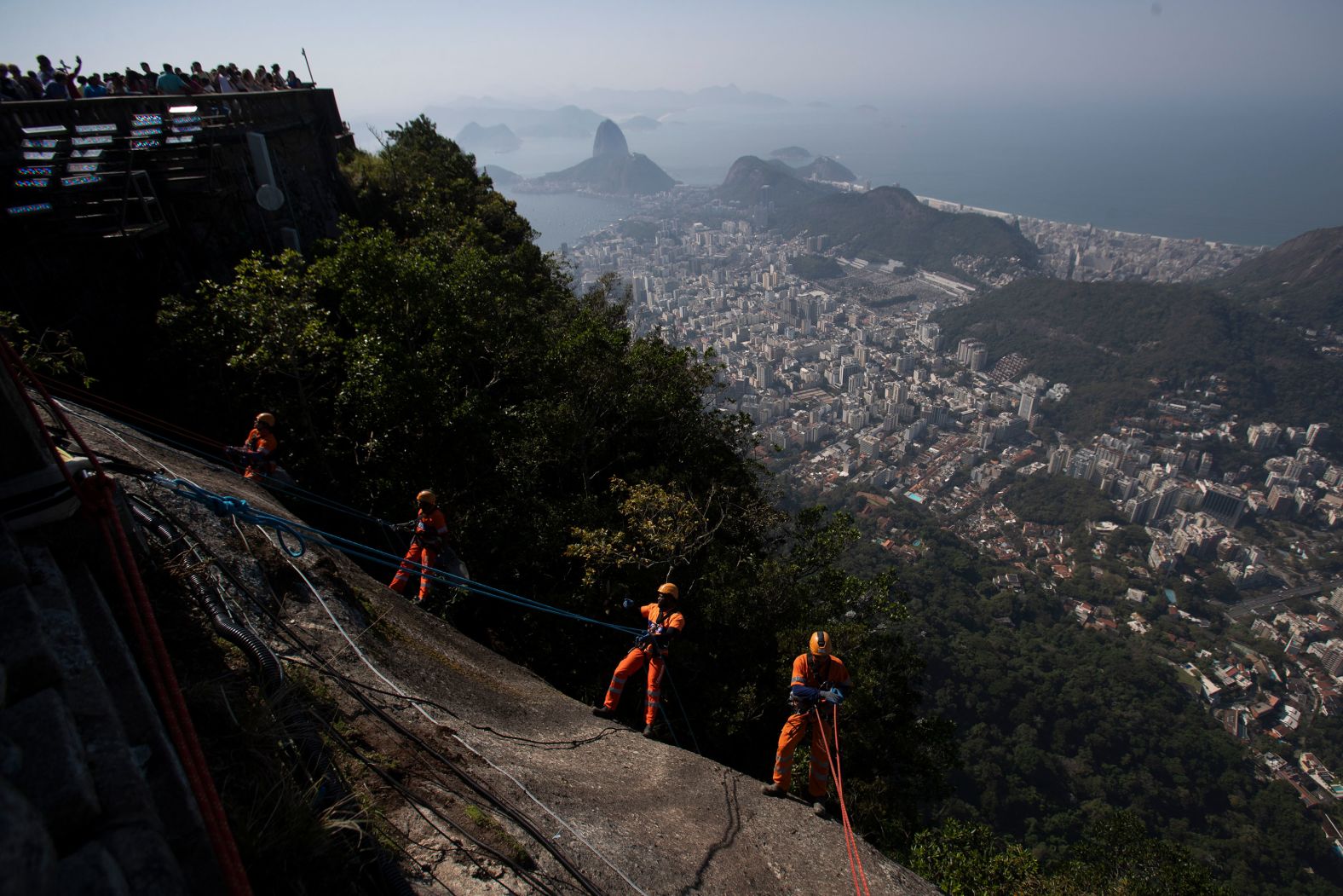 Trash collectors in Rio de Janeiro rappel down the Corcovado mountain to remove garbage from the slope of the Christ the Redeemer Statue on Thursday, August 22.