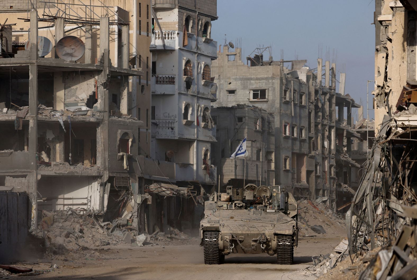 An Israeli armored vehicle drives past damaged buildings in Gaza on Friday, September 13.