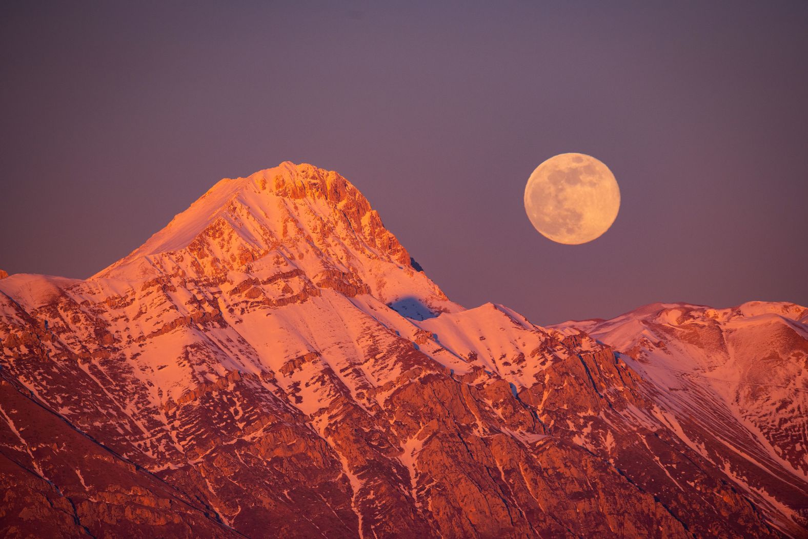 A full moon rises next to the Corno Grande and Pizzo Cefalone peaks in Italy on Thursday, January 25. <a href="index.php?page=&url=https%3A%2F%2Fwww.cnn.com%2F2024%2F01%2F25%2Fworld%2Fjanuary-full-wolf-moon-scn%2Findex.html">January’s full moon</a> is commonly called the wolf moon because wolves are active this time of year and can be heard howling on cold nights, according to the Old Farmer’s Almanac.