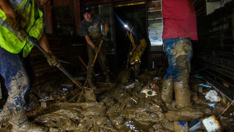 Friends help Sam Soughail, third from left, clear out his cigar bar at the Biltmore Village in Asheville, North Carolina, on October 1, 2024, in the aftermath of Hurricane Helene.