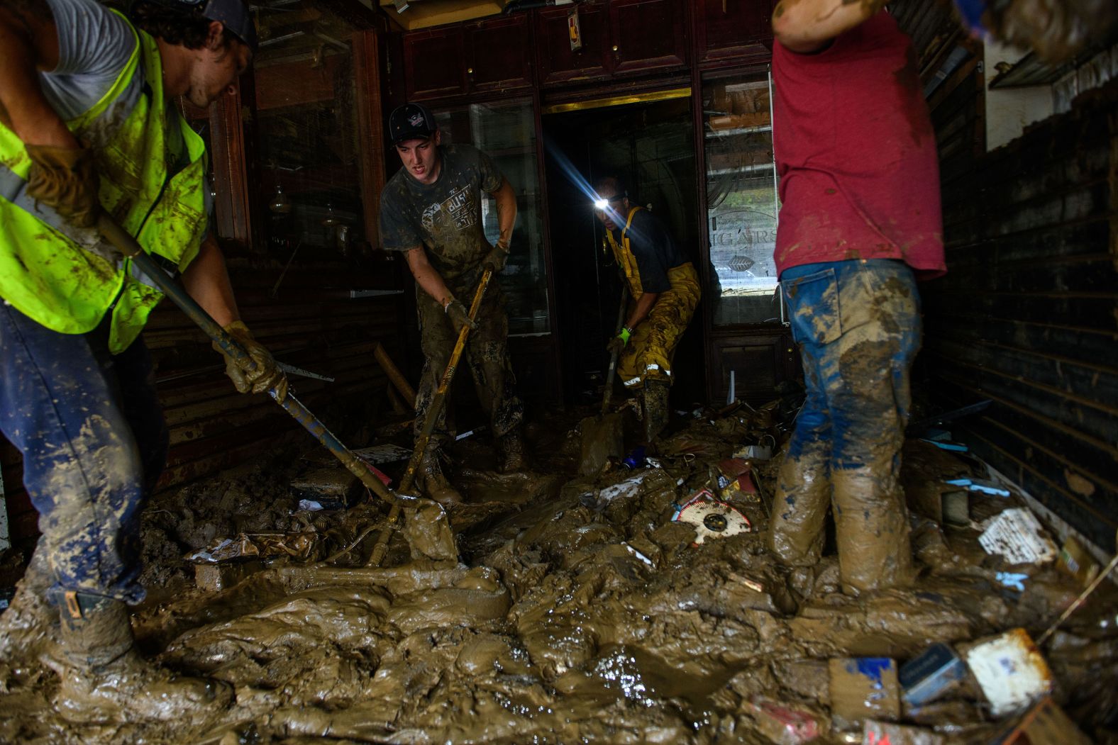 Friends help Sam Soughail, third from left, clear out his Casablanca Cigar Bar in Asheville, North Carolina, on Tuesday, October 1. The business was damaged by Hurricane Helene.