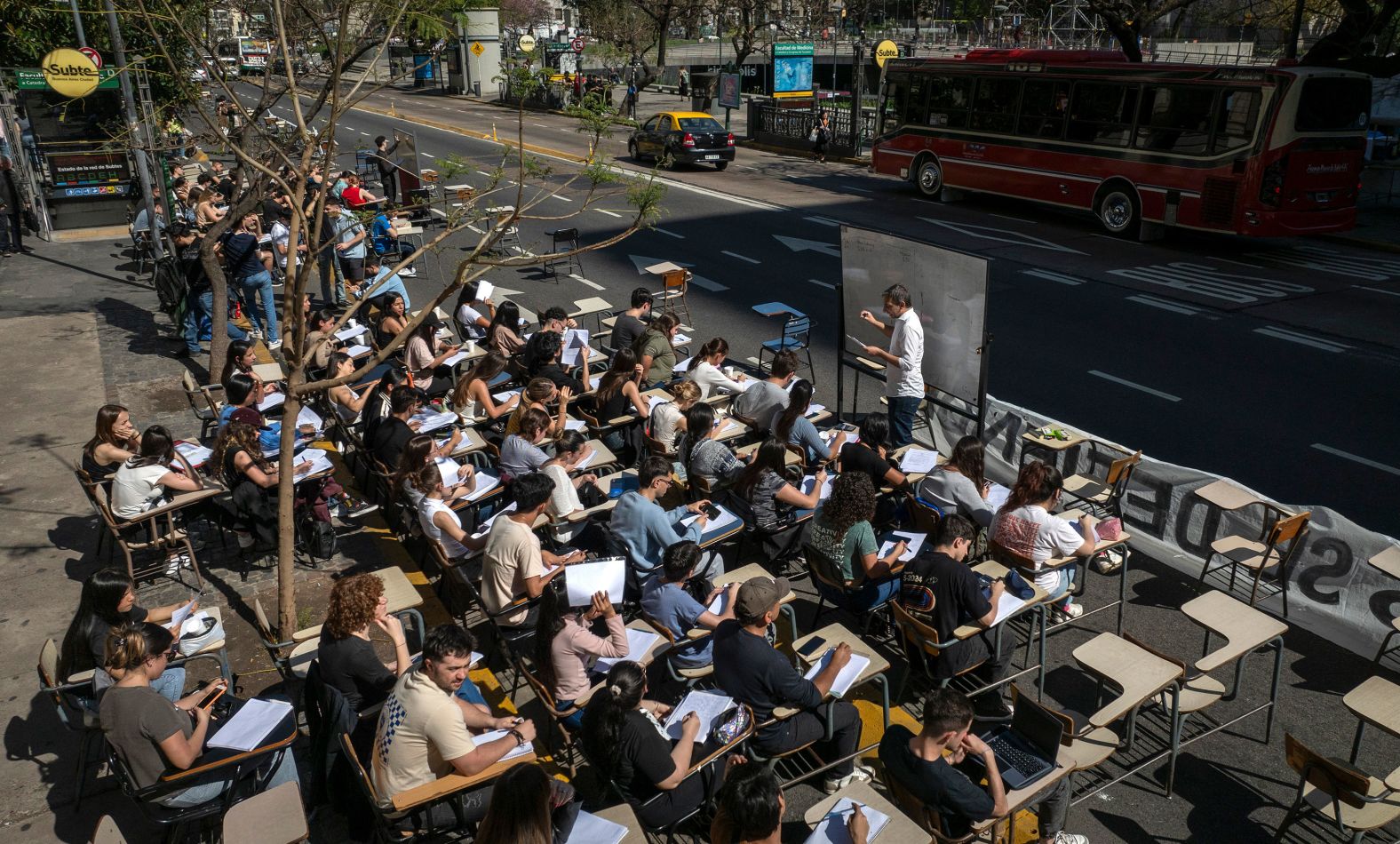 Economics students hold class in front of the University of Buenos Aires on Wednesday, October 16, as part of a protest against Argentine President Javier Milei, who vetoed higher funding for public universities.