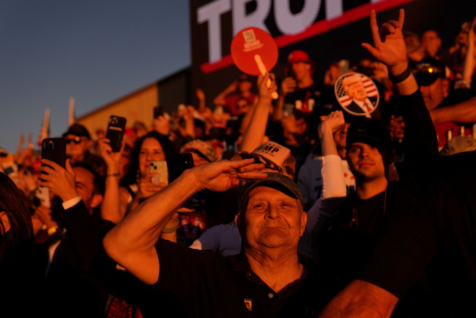 Supporters of former President Donald Trump watch as he arrives for a campaign rally in Latrobe, Pennsylvania, on Saturday, October 19.