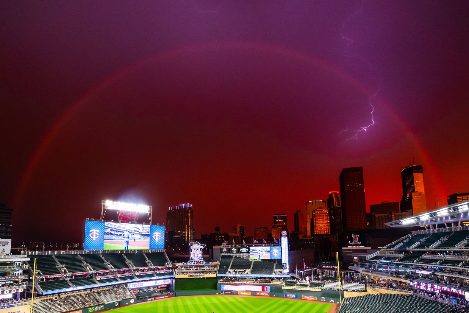 A rainbow and a lighting strike can be seen near Target Field, home of the Minnesota Twins, during a rain delay in Minneapolis on Monday, August 26.