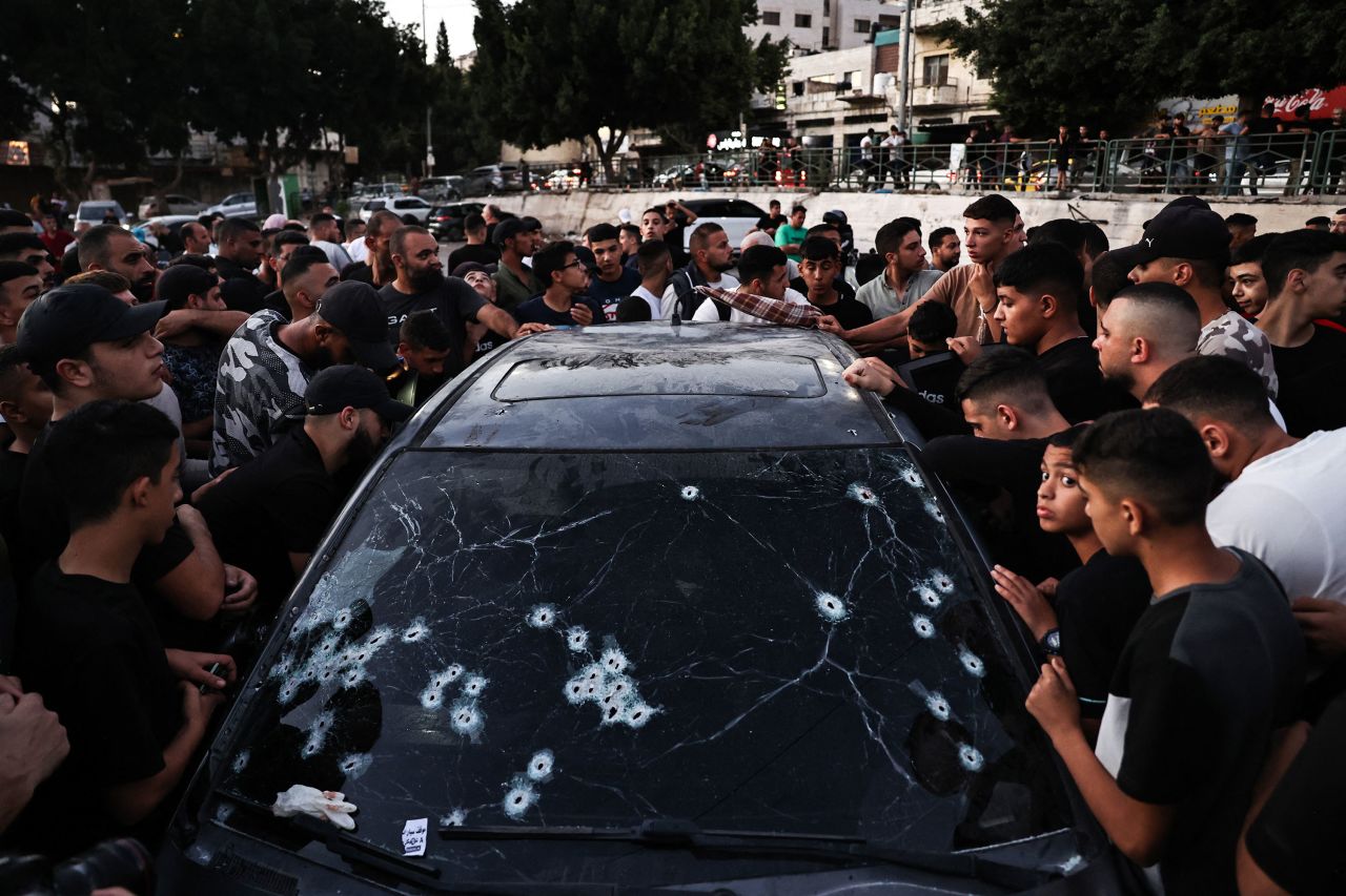 People inspect the bullet-riddled car in which four members of the Al-Aqsa Martyrs Brigades — a network of Palestinian armed groups — <a href="index.php?page=&url=https%3A%2F%2Fwww.cnn.com%2Fworld%2Flive-news%2Fisrael-gaza-lebanon-war-10-09-24-intl-hnk%23cm22eeb8k000f3b6moz2czdc8">were killed by Israeli special forces</a> in Nablus, in the occupied West Bank, on October 9, 2024.