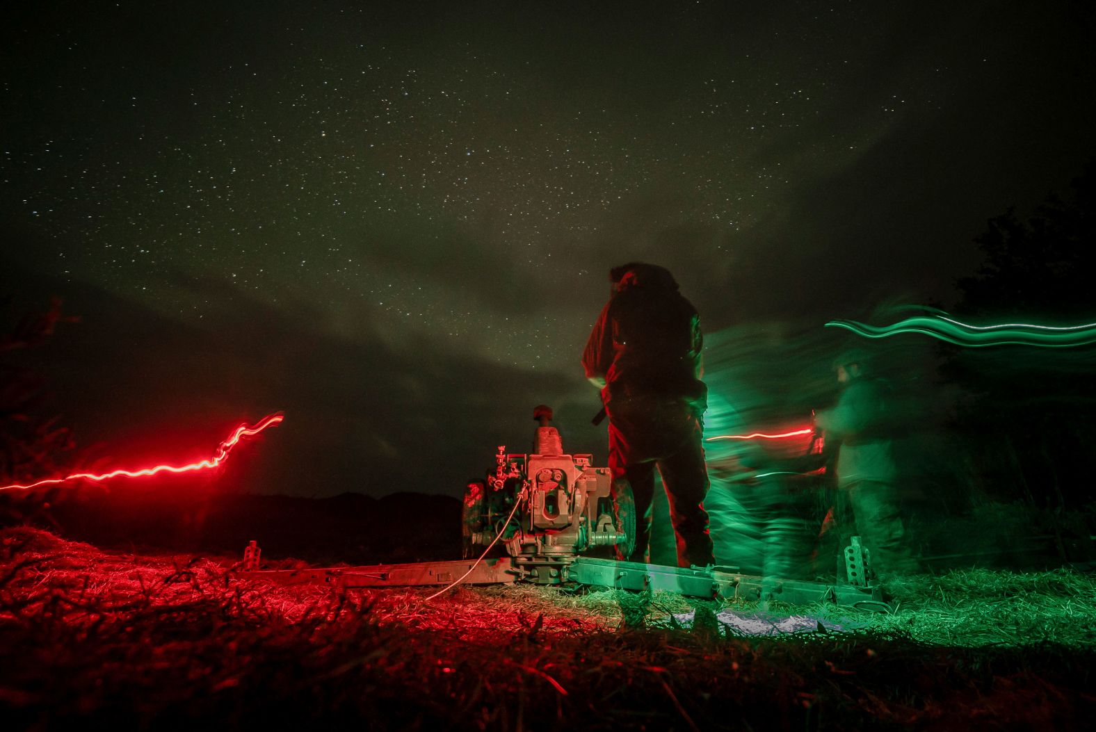 This long-exposure photo, taken on Sunday, October 27, shows Ukrainian servicemen preparing an artillery cannon before firing toward Russian positions in Ukraine’s Kherson region.