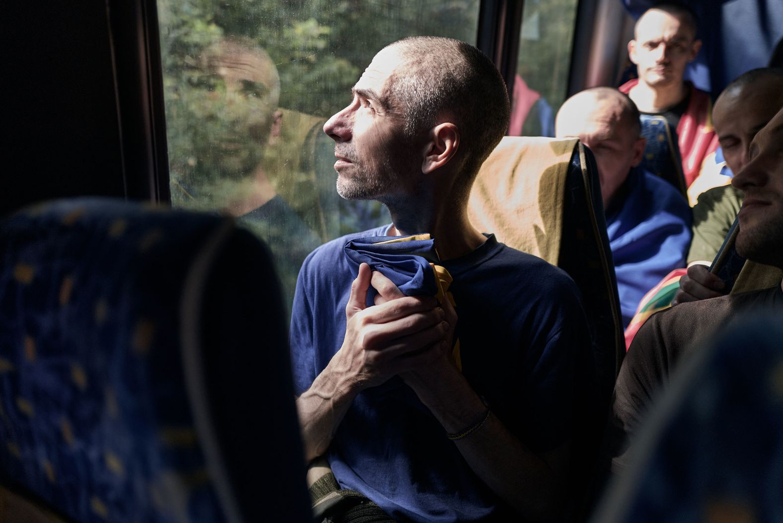 A man reacts on a bus as he and other Ukrainians return to their country after a <a  target="_blank">prisoner swap with Russia</a> on Friday, September 13.