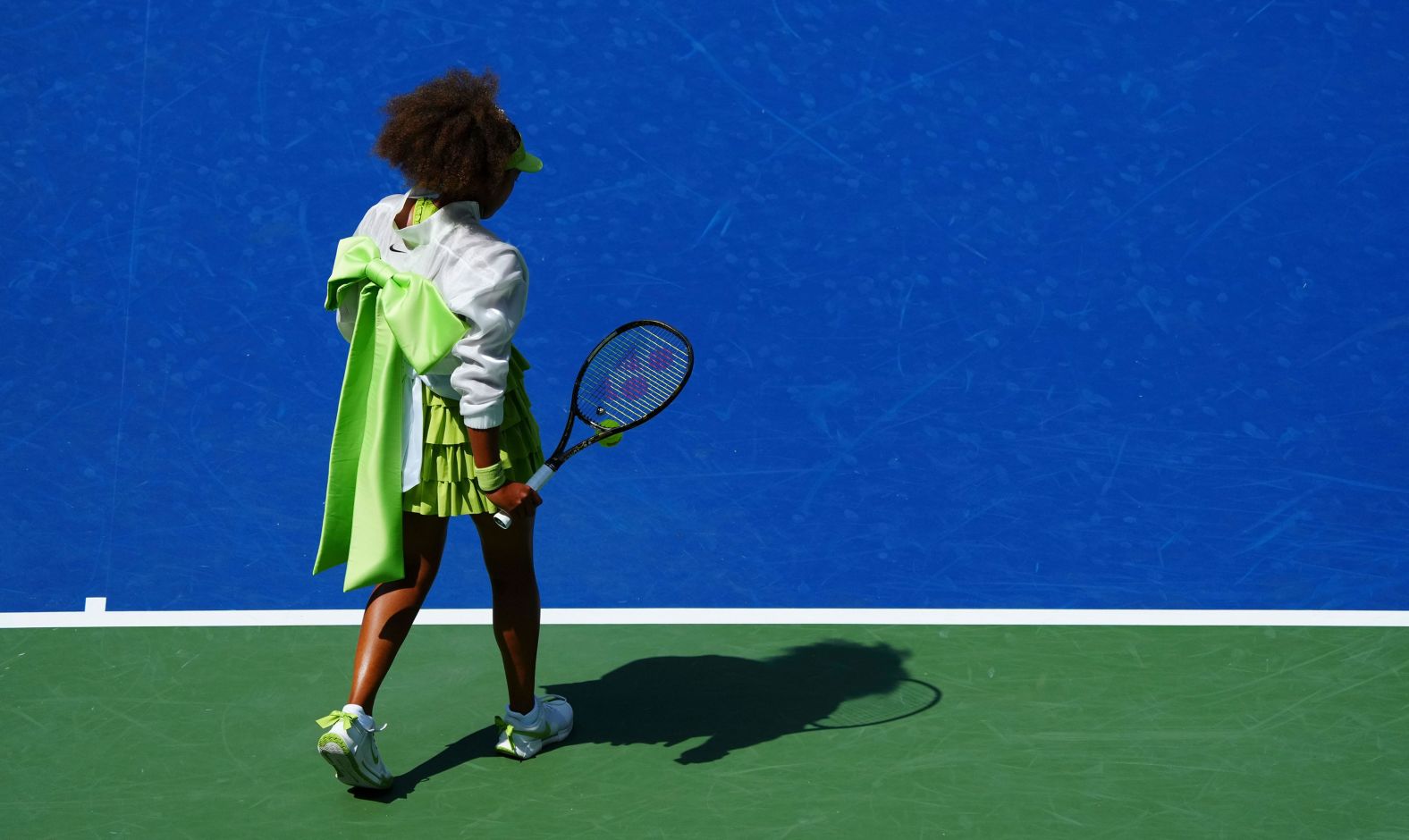 Naomi Osaka wears an eye-catching green bow before her <a >first-round win at the US Open</a> on Tuesday, August 27. Osaka, a two-time US Open champion, defeated No. 10 seed Jelena Ostapenko 6-3, 6-2.