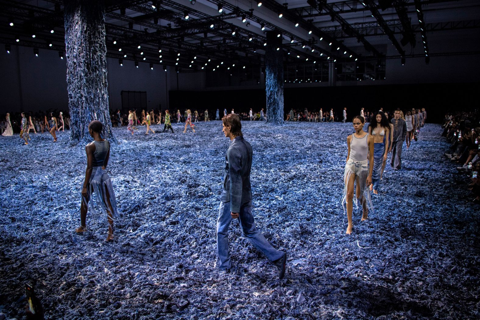 Models walk along a floor covered in denim scraps during the Diesel show at Milan Fashion Week on Saturday, September 21.