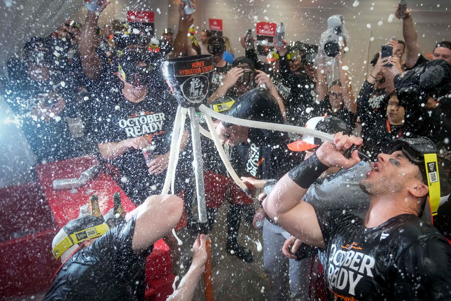 Baltimore Orioles players celebrate in their locker room after clinching a playoff berth in New York on Tuesday, September 24.