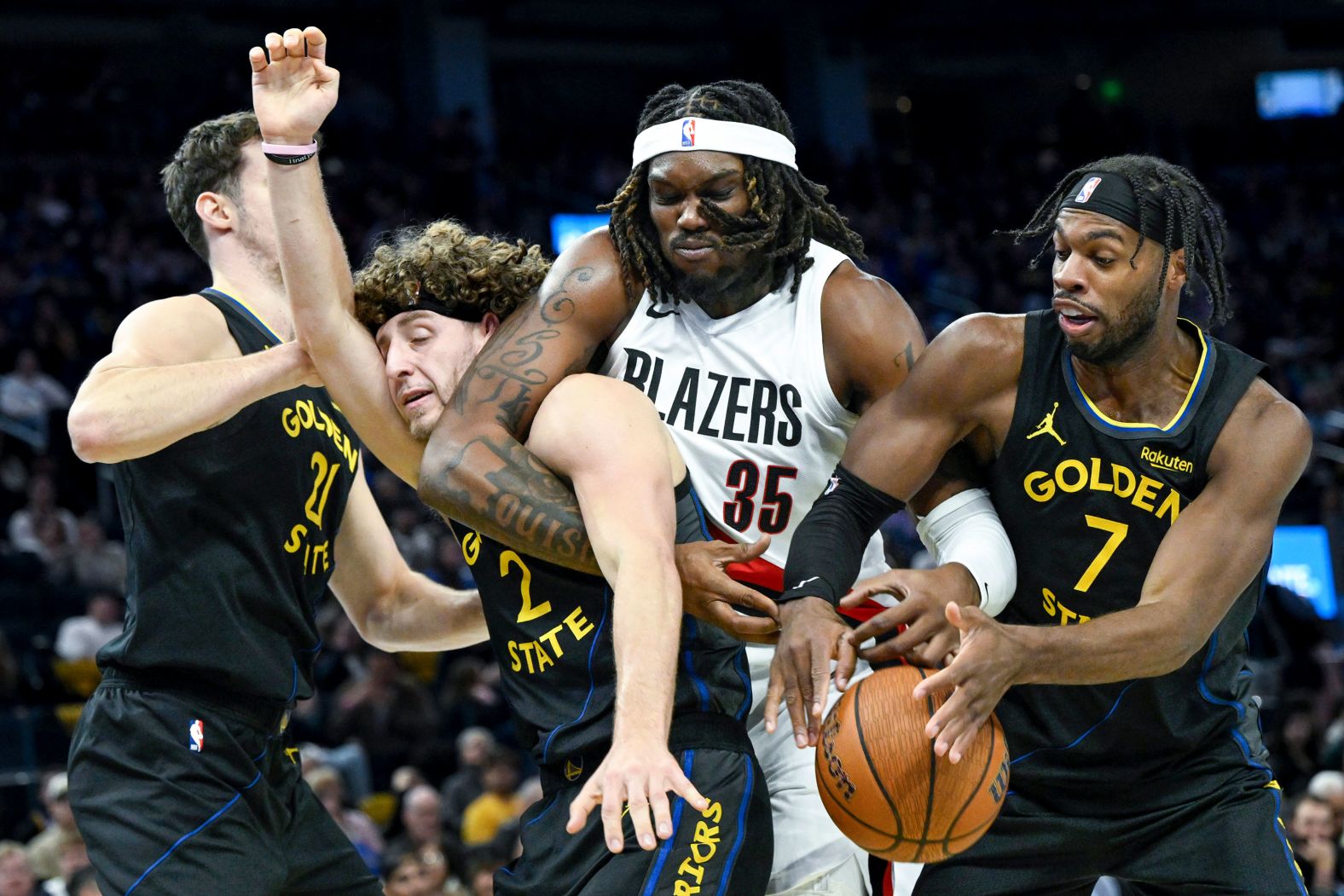 The Portland Trail Blazers’ Robert Williams III battles several Golden State Warriors for a rebound during an NBA game in San Francisco on Friday, November 21.