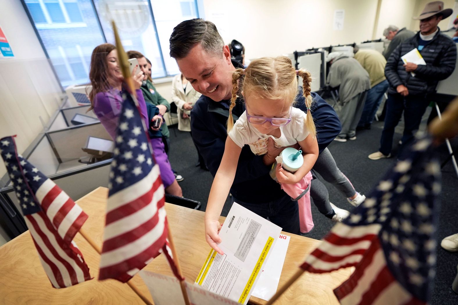 US Rep. Zach Nunn holds his daughter Aliya as he casts an early ballot in Des Moines, Iowa, on Wednesday, October 16.