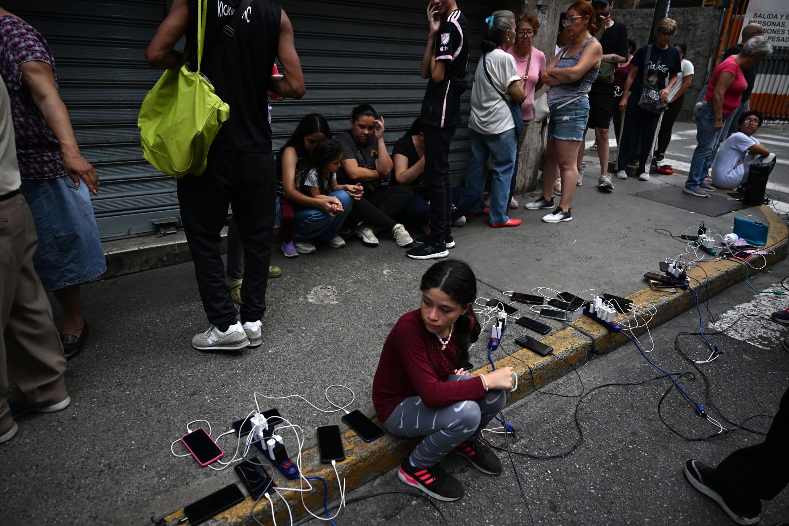 People charge their phones from a truck during a <a  target="_blank">blackout in Caracas</a>, Venezuela, on Friday, August 30. Venezuelans spent most of Friday in the dark as a major outage knocked out power in the capital and several states, according to the Associated Press.