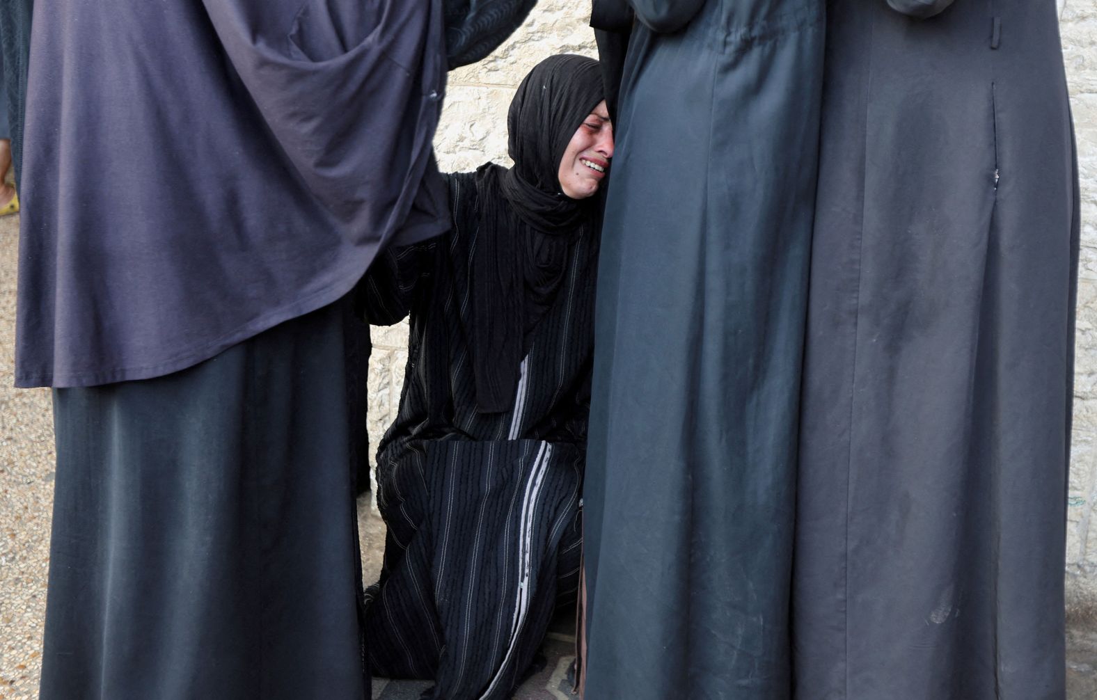 A Palestinian mourns a relative, who was killed in an Israeli strike, at a hospital in Deir al-Balah, Gaza, on Saturday, August 17.