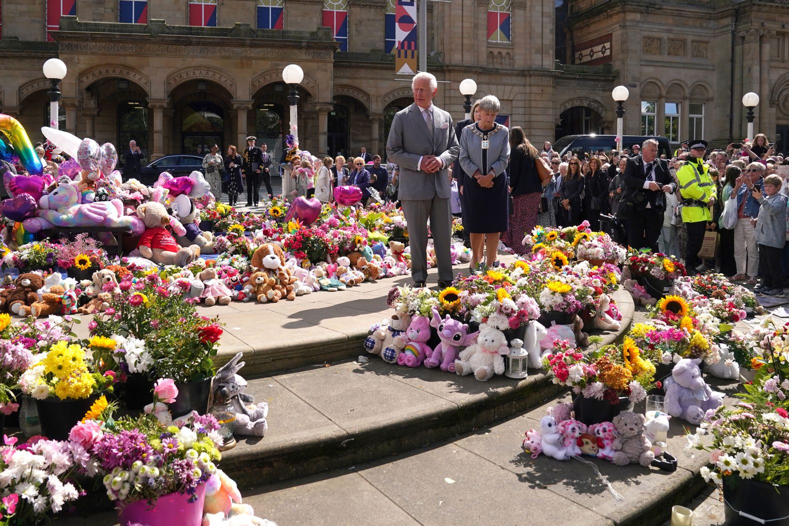 Britain’s King Charles III walks in Southport, England, on Tuesday, August 20, viewing flowers and tributes that were left for the three young victims of a <a >stabbing attack</a> in July.