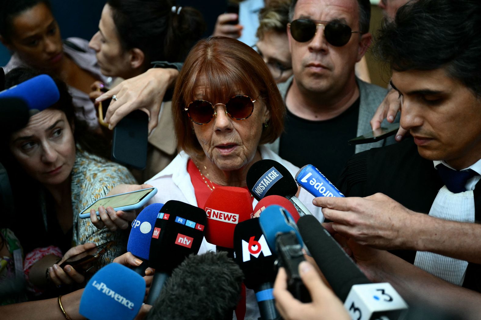 A 72-year-old woman named Gisèle talks to the media as she leaves a courthouse in Mazan, France, on Thursday, September 5. Her husband, Dominique, <a >is accused of repeatedly drugging and raping her as well as encouraging dozens of other men to rape her in their home while she was unconscious</a>, court documents show. For the next four months, she will come face to face with her accused abusers, most of whom are complete strangers to her. CNN is not using the full names of Gisèle and Dominique to protect the identities of other family members.