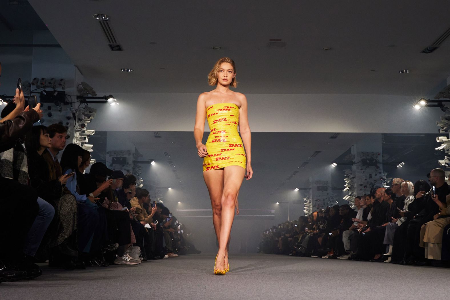 Model Gigi Hadid walks the runway in a <a href="index.php?page=&url=https%3A%2F%2Fwww.cnn.com%2F2024%2F09%2F30%2Fstyle%2Flook-of-the-week-gigi-hadid-mini-dress-packing-tape%2Findex.html">mini dress made of packing tape</a> during a Paris Fashion Week show on Friday, September 27.