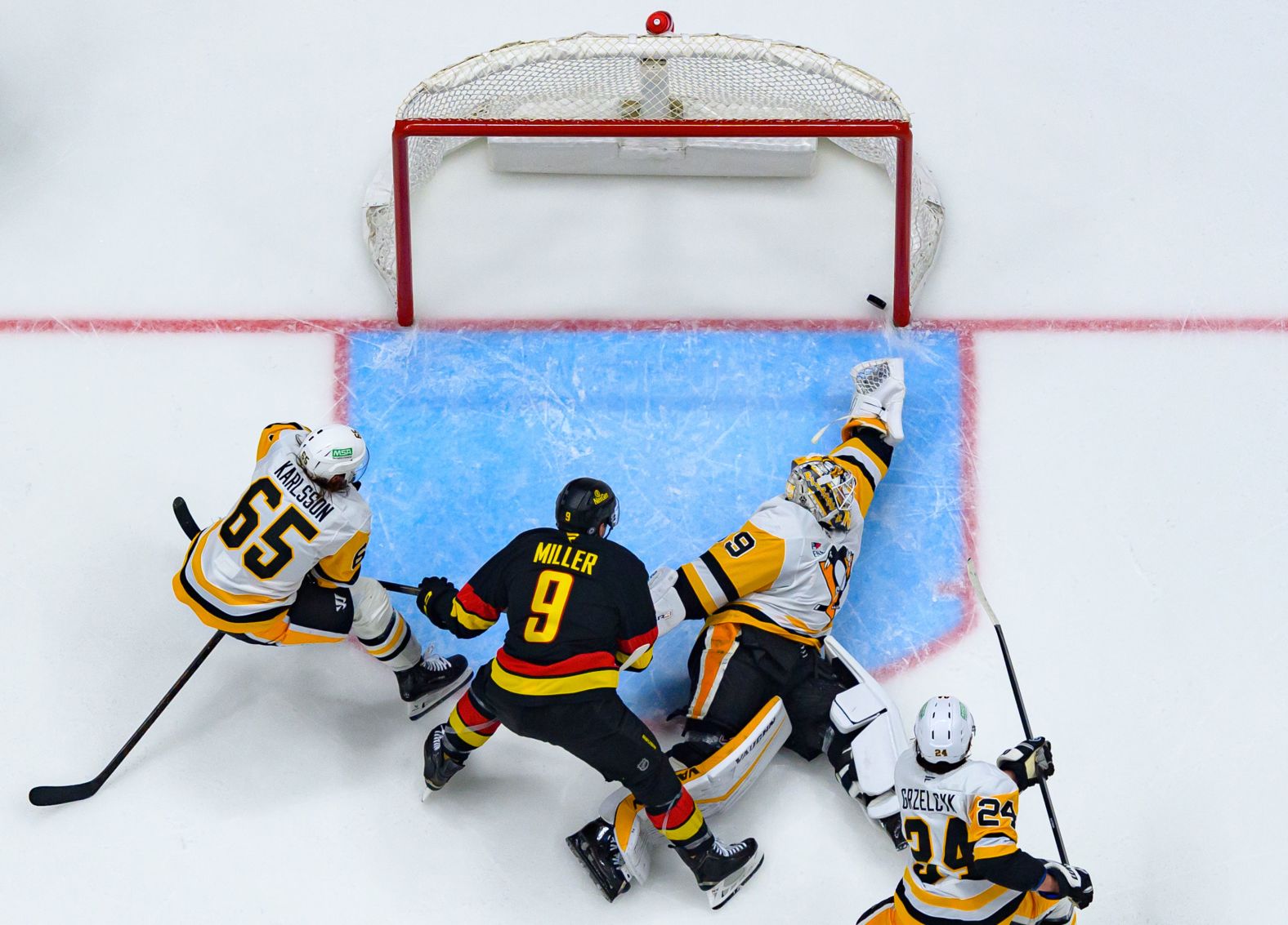 The Vancouver Canucks’ J.T. Miller, second from left, scores a goal against Pittsburgh during an NHL game in Vancouver, British Columbia, on Saturday, October 26.