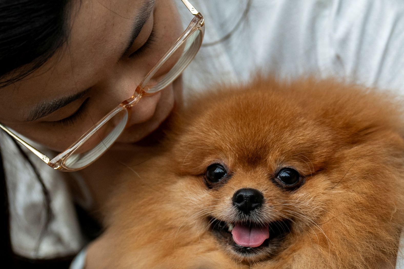 A woman carries her dog before a pet-blessing ceremony at a mall in Quezon City, Philippines, on Sunday, October 6.