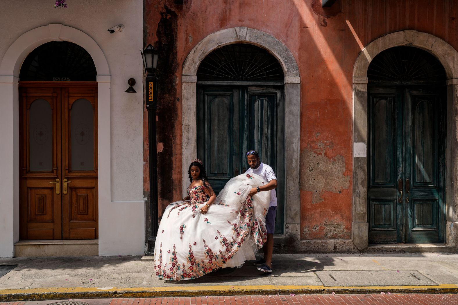 A man holds his daughter's dress at the Casco Viejo neighborhood in Panama City, Panama, on Sunday, September 15.