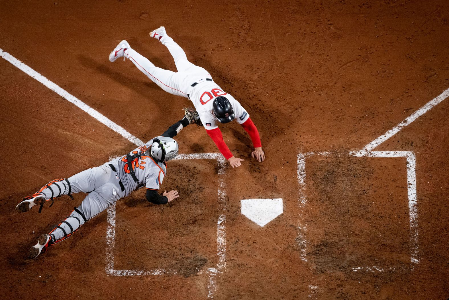 Baltimore Orioles catcher Adley Rutschman tags out Rob Refsnyder of the Boston Red Sox during a Major League Baseball game in Boston on Monday, September 9.