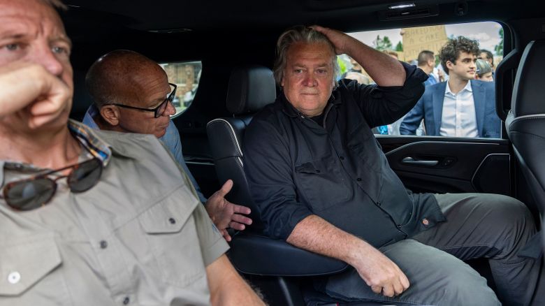 Steve Bannon sits with Erik Prince, foreground left, who founded the private military firm Blackwater Worldwide and a prominent supporter of former President Donald Trump, before surrendering outside the Federal Correctional Institution in Danbury, Conn., on Monday morning, July 1, 2024. Bannon, a longtime ally of former President Donald Trump, is scheduled to surrender at the prison on Monday to begin serving a four-month sentence for contempt of Congress. (Adam Gray/The New York Times)