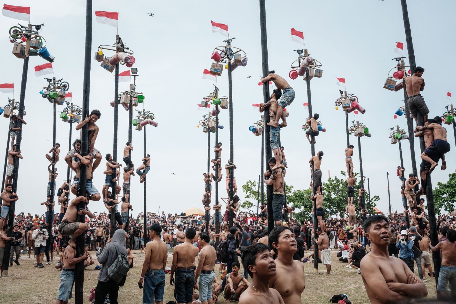 People take part in Panjat Pinang, a traditional game where you climb greased tree poles to collect prizes, during Independence Day celebrations in Jakarta, Indonesia, on Saturday, August 17.