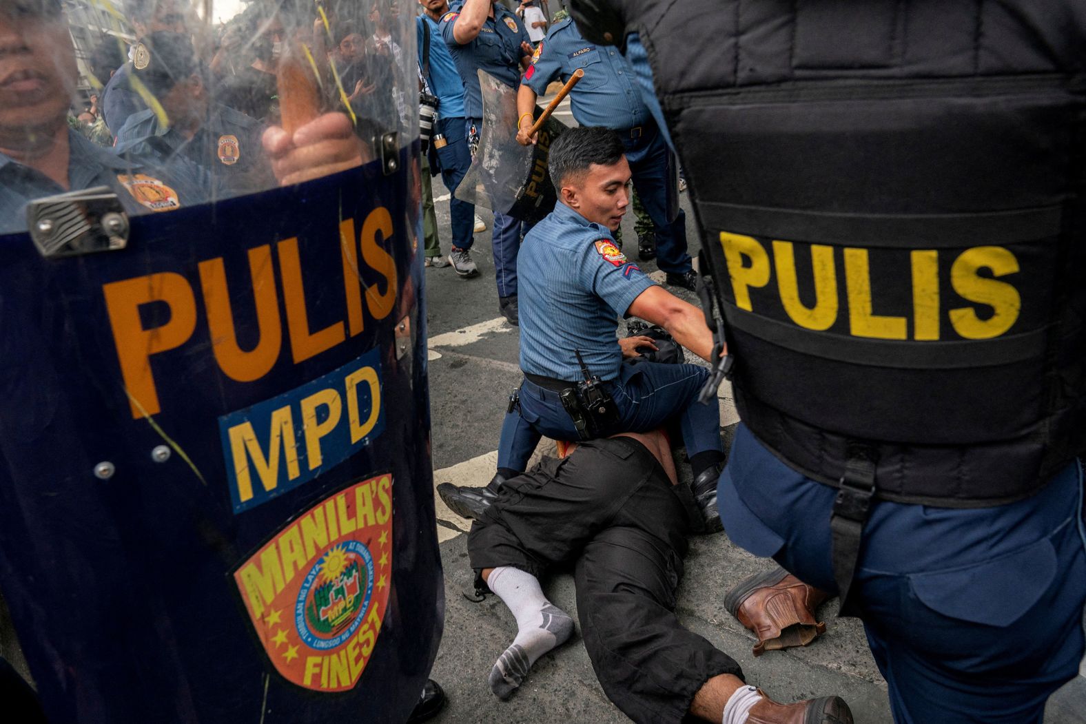 A police officer pins an activist to the ground during a protest commemorating the 52nd anniversary of the 1972 martial law declaration in Manila, Philippines, on Saturday, September 21.