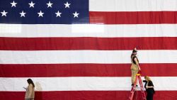 Advance staff for the Harris-Walz campaign steam wrinkles out of the US national flag beingused as a backdrop for former US President Barack Obama as he campaigns for US Vice President and Democratic presidential candidate Kamala Harris in Pittsburgh, Pennsylvania, on October 10, 2024. (Photo by RYAN COLLERD / AFP) (Photo by RYAN COLLERD/AFP via Getty Images)