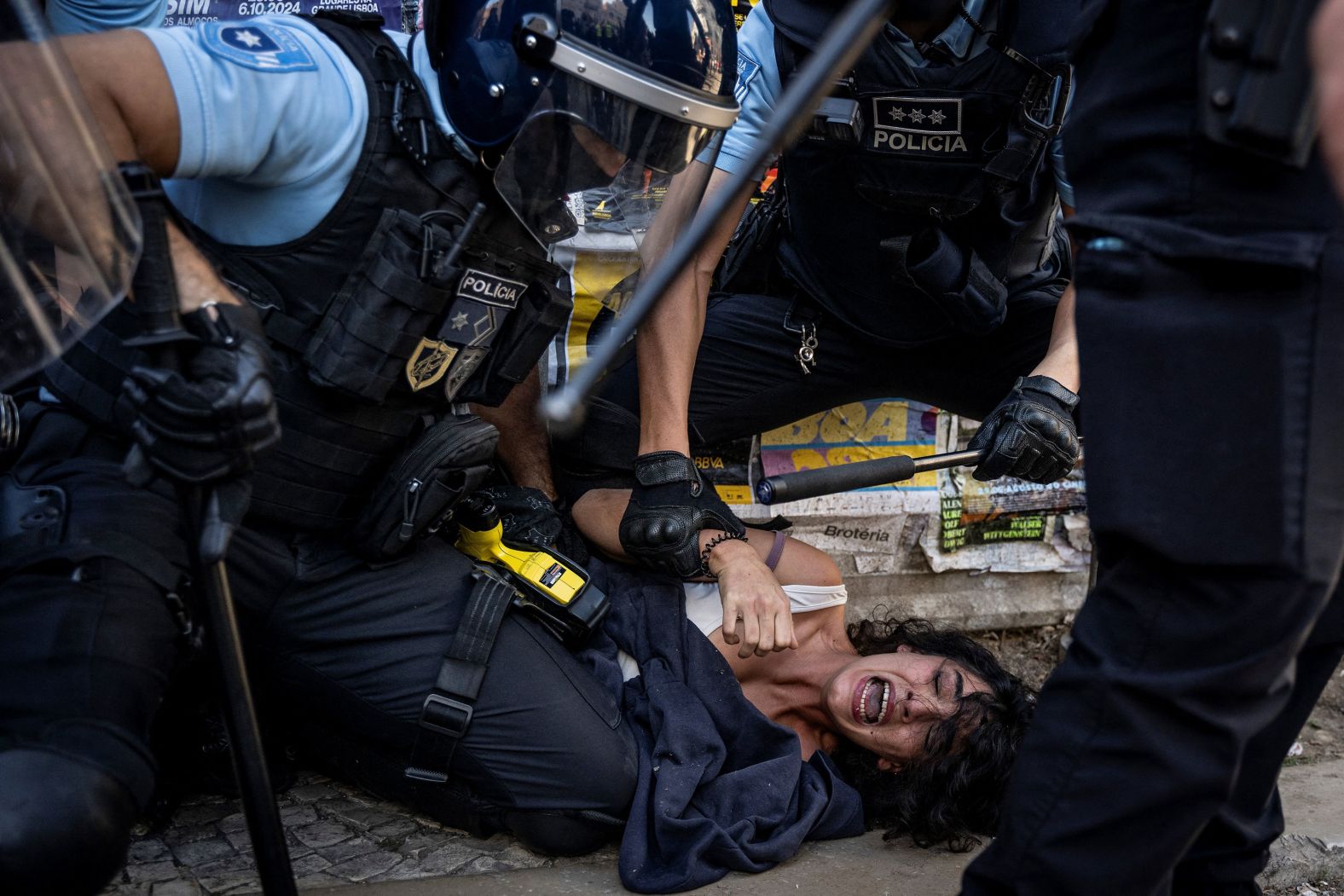 Police in Lisbon, Portugal, detain a woman that was protesting Sunday, September 29, against a demonstration called by the far-right party Chega against "uncontrolled immigration.”