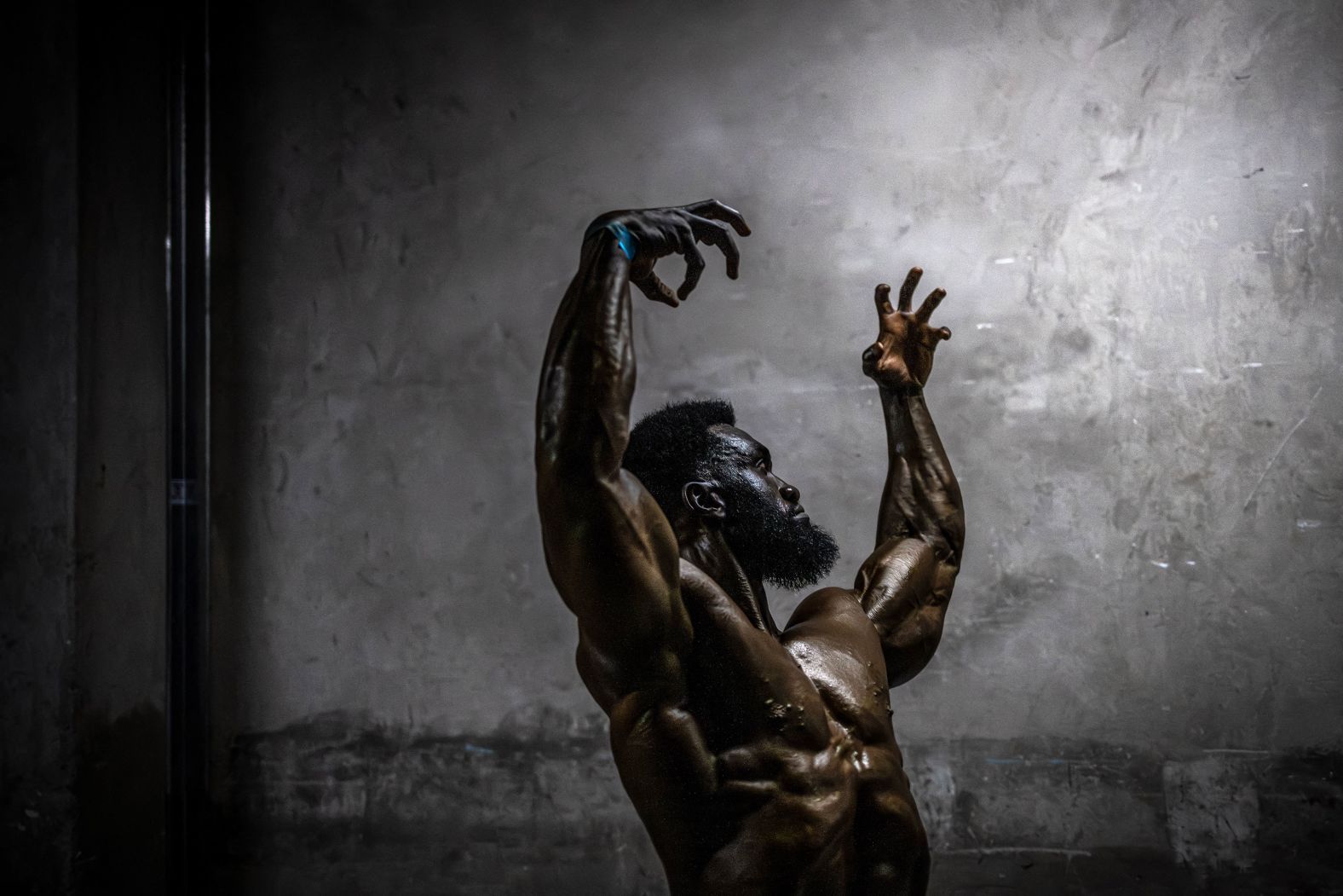 A competitor strikes some poses while warming up backstage at the Mr. and Miss East Africa Bodybuilding Contest in Nairobi, Kenya, on Saturday, October 12.