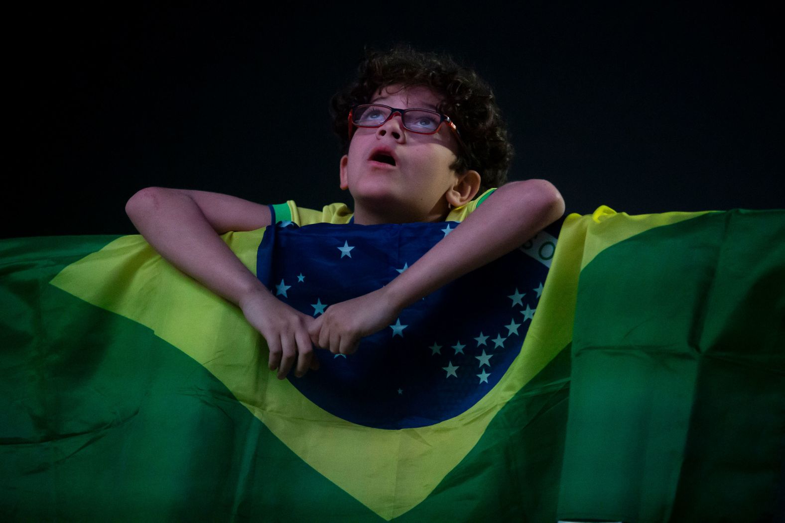 A young fan in Rio de Janeiro watches Brazil’s soccer team play a Copa América match in Santa Clara, California, on Tuesday, July 2.