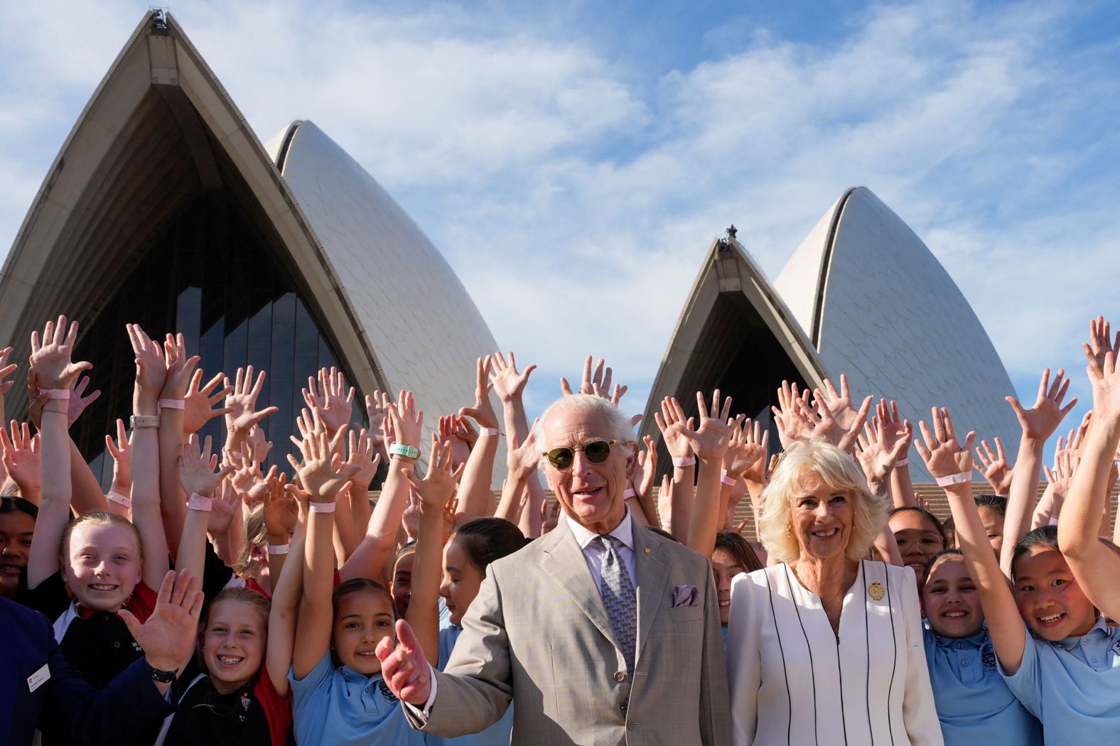 Britain's King Charles III and his wife, Queen Camilla, pose for a group photo during their visit to the Sydney Opera House on Tuesday, October 22. Charles is making <a href="index.php?page=&url=https%3A%2F%2Fwww.cnn.com%2F2024%2F10%2F19%2Faustralia%2Fking-charles-australia-tour-intl-hnk%2Findex.html">his first major foreign trip</a> since being diagnosed with cancer.