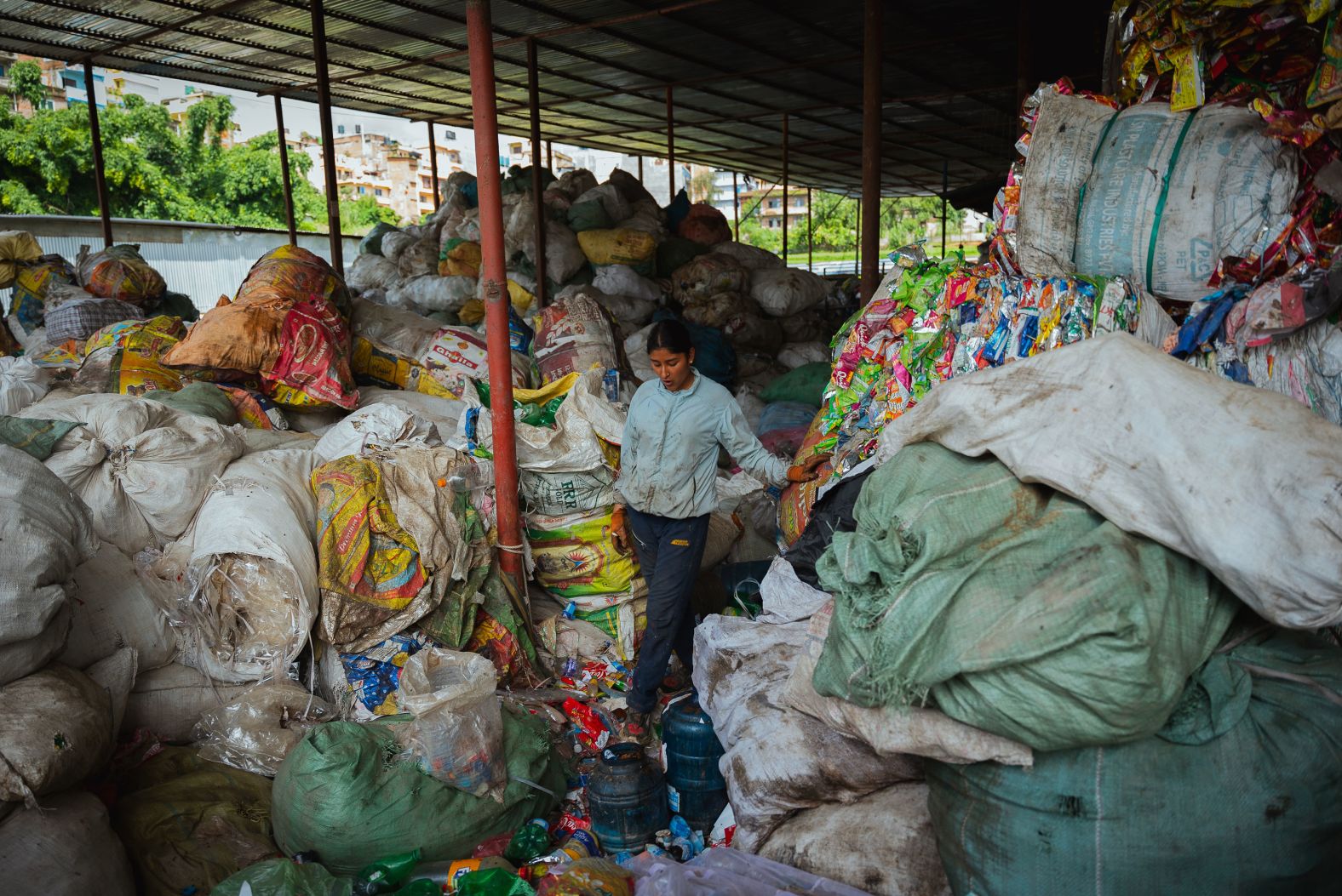 A worker pauses for a moment while sorting through recyclable goods at the Avni recycling plant in Kathmandu, Nepal, on Sunday, August 18.