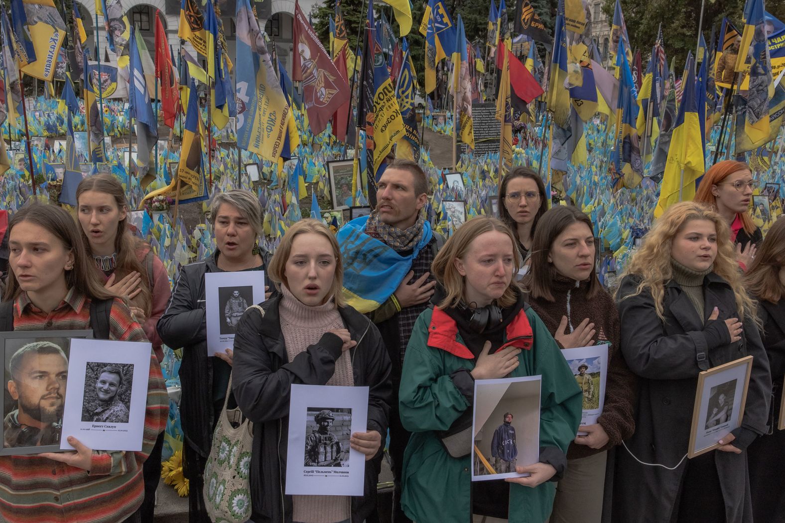 People hold portraits and sing Ukraine’s national anthem as they commemorate the country’s Defenders Day in the capital of Kyiv on Tuesday, October 1. <a href="index.php?page=&url=https%3A%2F%2Fwww.cnn.com%2Feurope%2Flive-news%2Frussia-ukraine-war-news-10-01-23%23h_87d63730f63c1594f916ce71836fd0d0">The holiday</a> honors the country’s veterans and war dead. The observance has held particular importance in the last two years given Russia’s invasion.