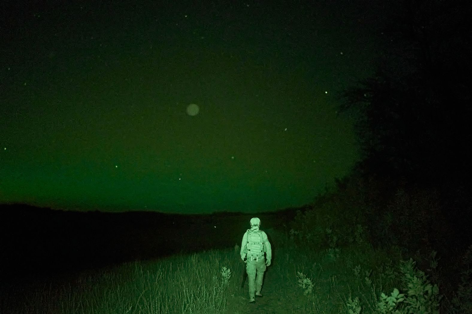 In this photo, which was taken with an infrared thermal imaging camera, a Ukrainian soldier surveys an area in the country’s Kharkiv region on Monday, July 1.