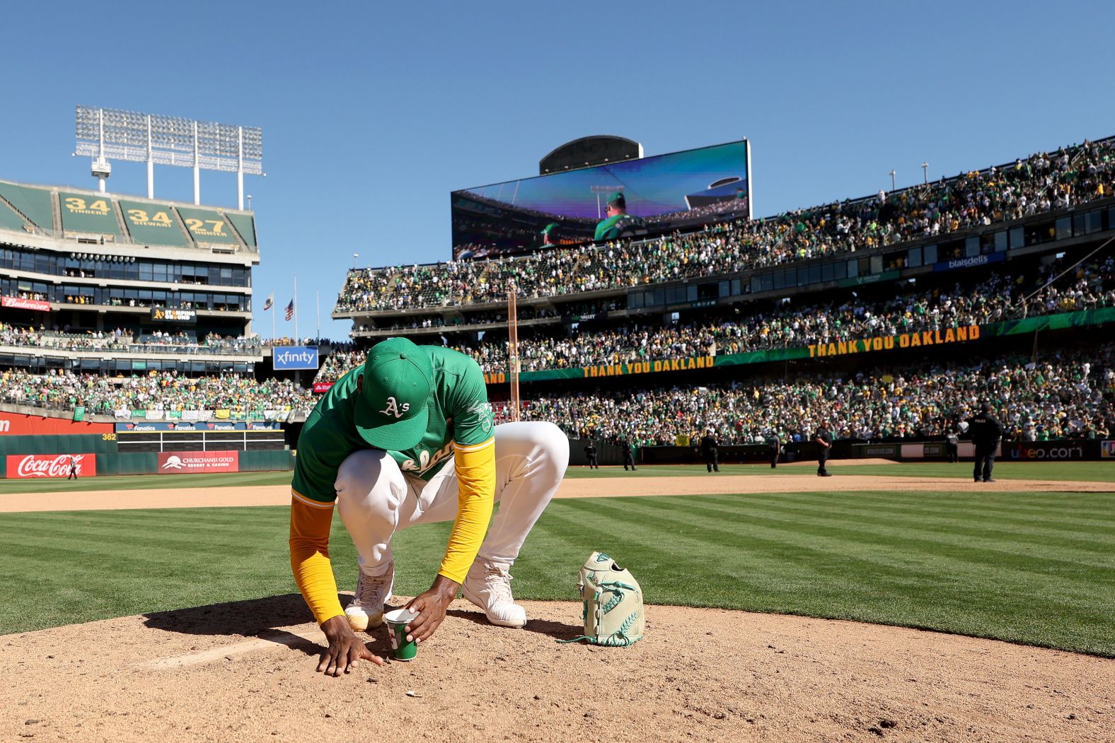 Oakland Athletics pitcher Michel Otañez takes dirt from the pitcher’s mound after <a href="index.php?page=&url=https%3A%2F%2Fwww.cnn.com%2F2024%2F09%2F26%2Fsport%2Fathletics-bid-farewell-to-oakland-spt-intl%2Findex.html">the final game played at the Oakland Coliseum</a> on Thursday, September 26. The team is moving after 57 seasons. It will be relocating to West Sacramento, California, next season, before a permanent move to Las Vegas.