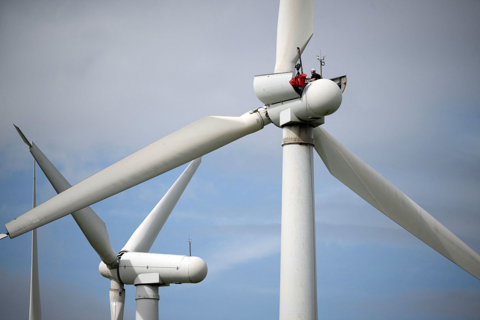 A worker services a wind turbine at the Royd Moor wind farm in northern England on Tuesday, September 3.