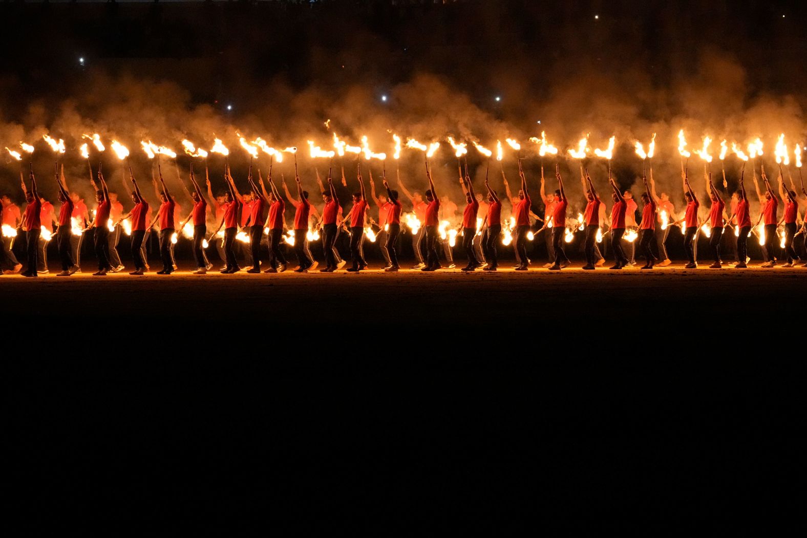 Artists carry burning torches as they perform during a cultural show as part of Dussehra festivities in Mysuru, India, on Friday, October 11.