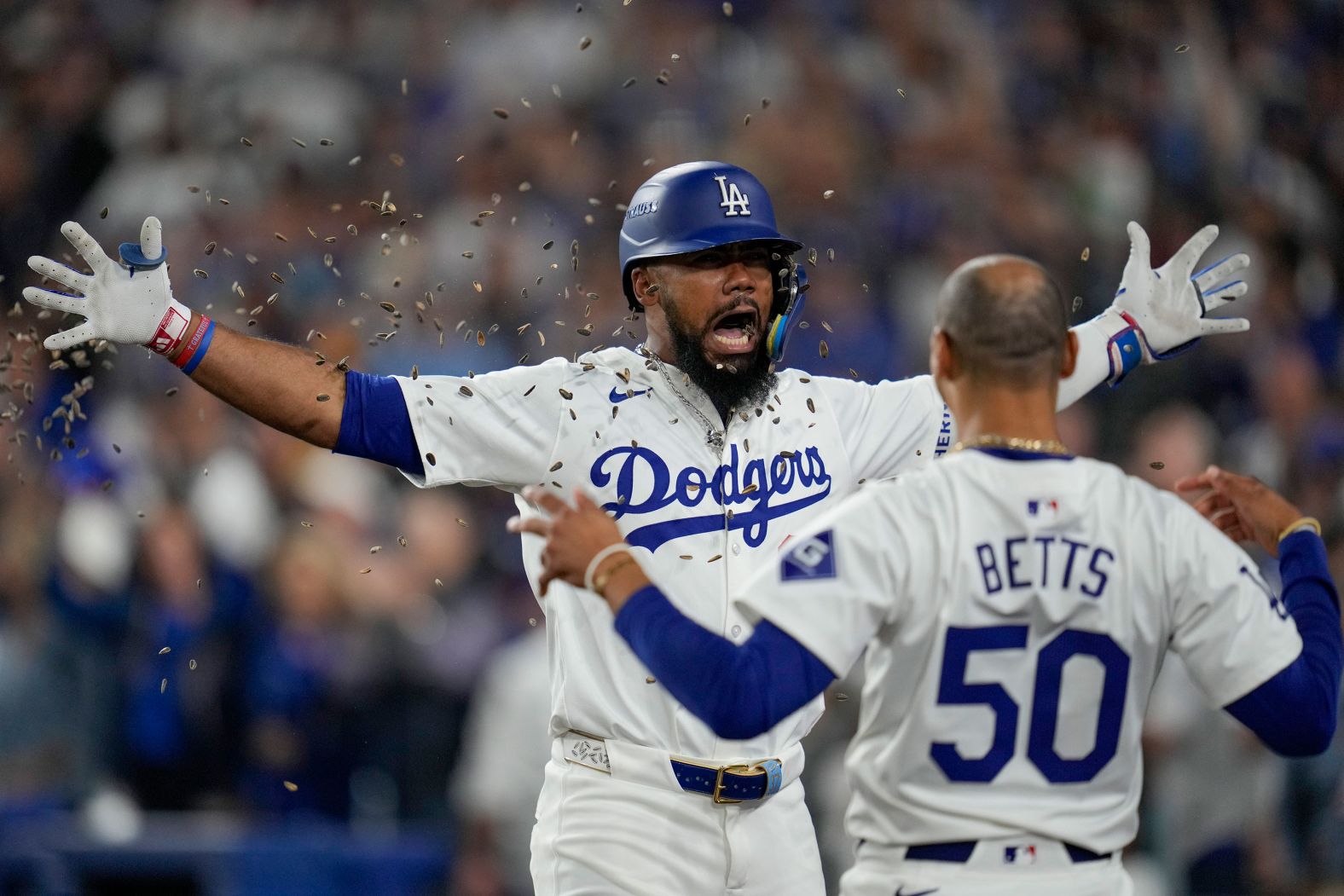 The Los Angeles Dodgers’ Teoscar Hernández, left, is showered with sunflower seeds after hitting a home run in Game 5 of the Dodgers’ playoff series against the San Diego Padres on Friday, October 11. Los Angeles won 2-0 and advanced to the National League Championship Series against the New York Mets.