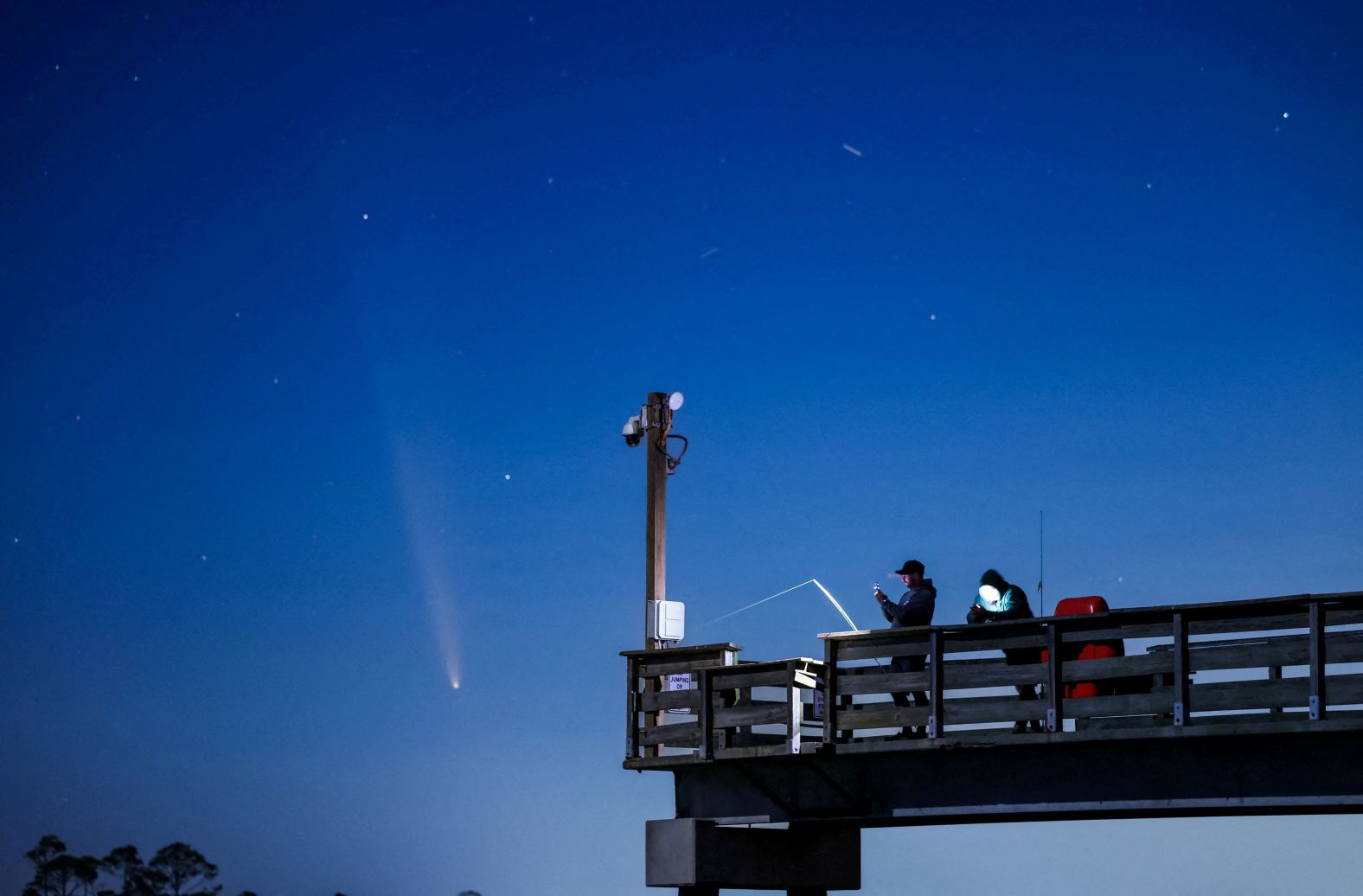 A recently discovered comet <a href="https://www.cnn.com/2024/10/09/science/comet-tsuchinshan-atlas-earth/index.html">known as C/2023 A3 Tsuchinshan–ATLAS</a> can be seen in the sky as two men fish off a pier in Tybee Island, Georgia, on Sunday, October 13. <a href="https://www.cnn.com/2024/10/10/world/gallery/photos-this-week-october-3-october-10/index.html">See last week in 31 photos</a>.