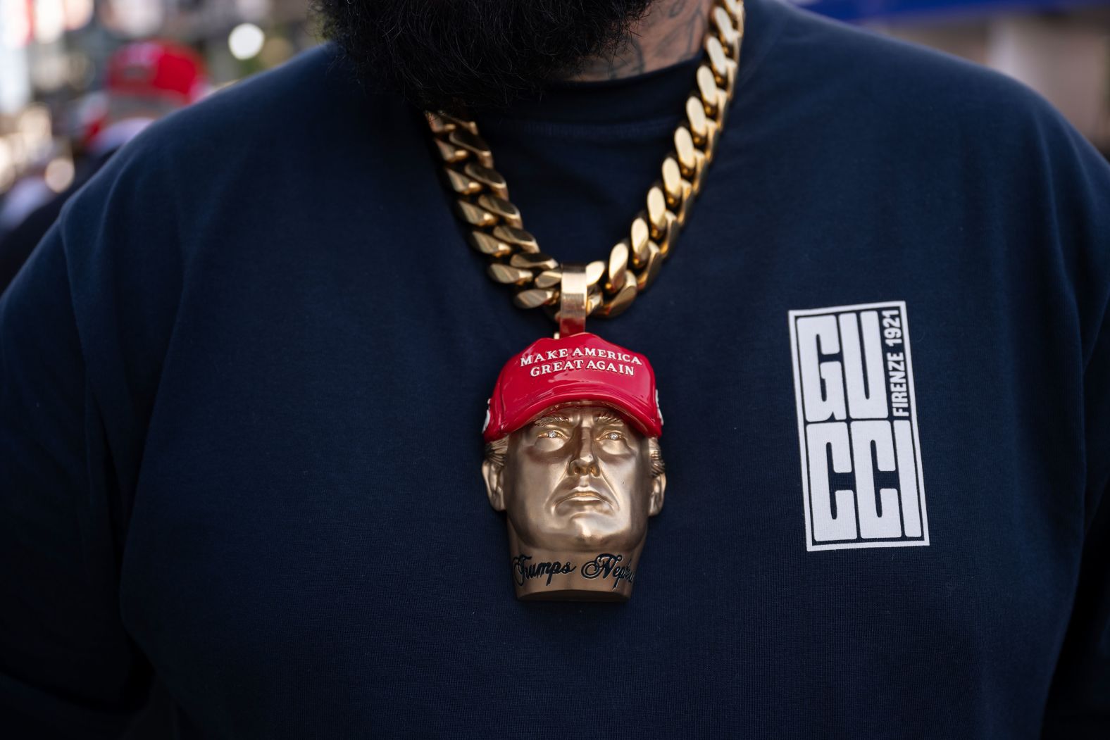 Rapper Forgiato Blow wears a Trump medallion around his neck on Thursday.